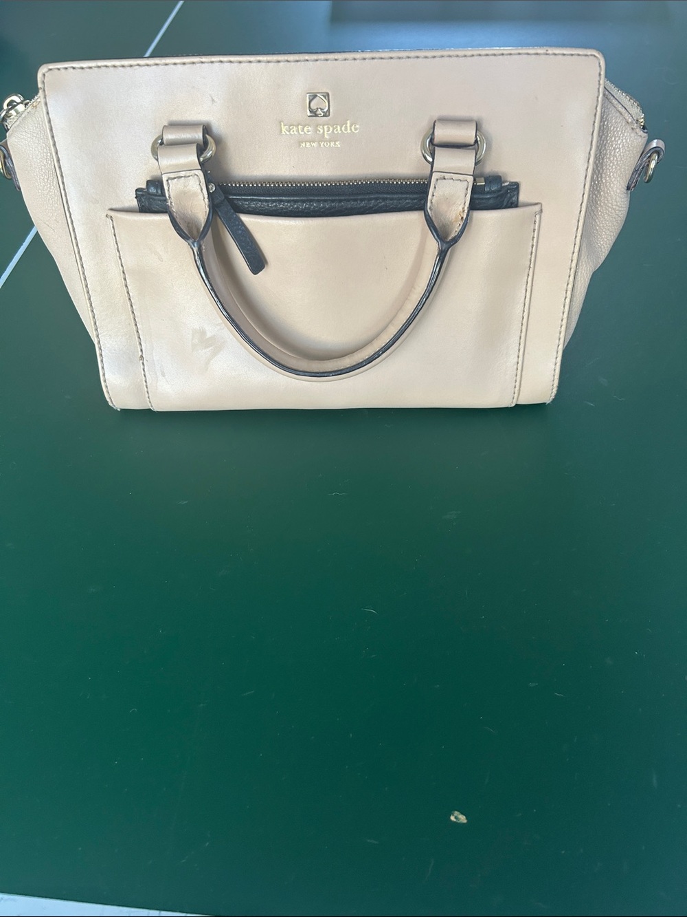 kate spade beige leather satchel. There are minor interior lining stains.